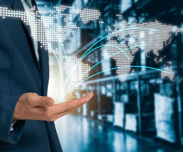 World map on hand businessman with Modern Trade warehouse logistics, uncle plans to invest in transport, from domestic to global.Industry 4.0 concept,planning of logistics.