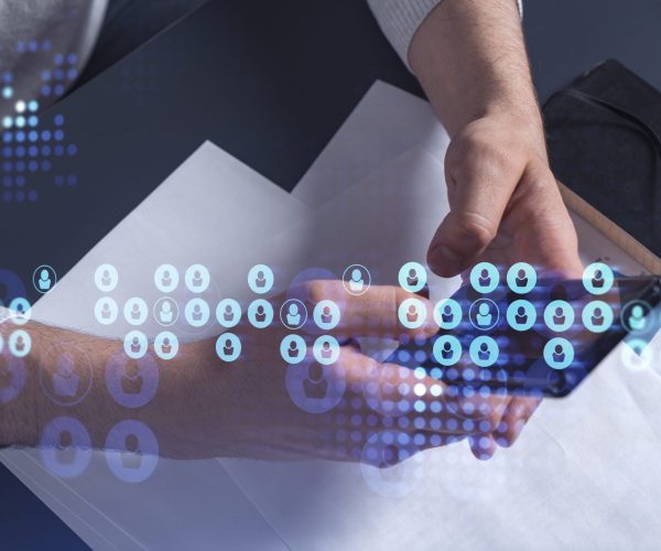 Hands of hr specialist browsing social networks in the Internet in smart phone to find the best candidates to hire international team. Concept of success. Media hologram icons.